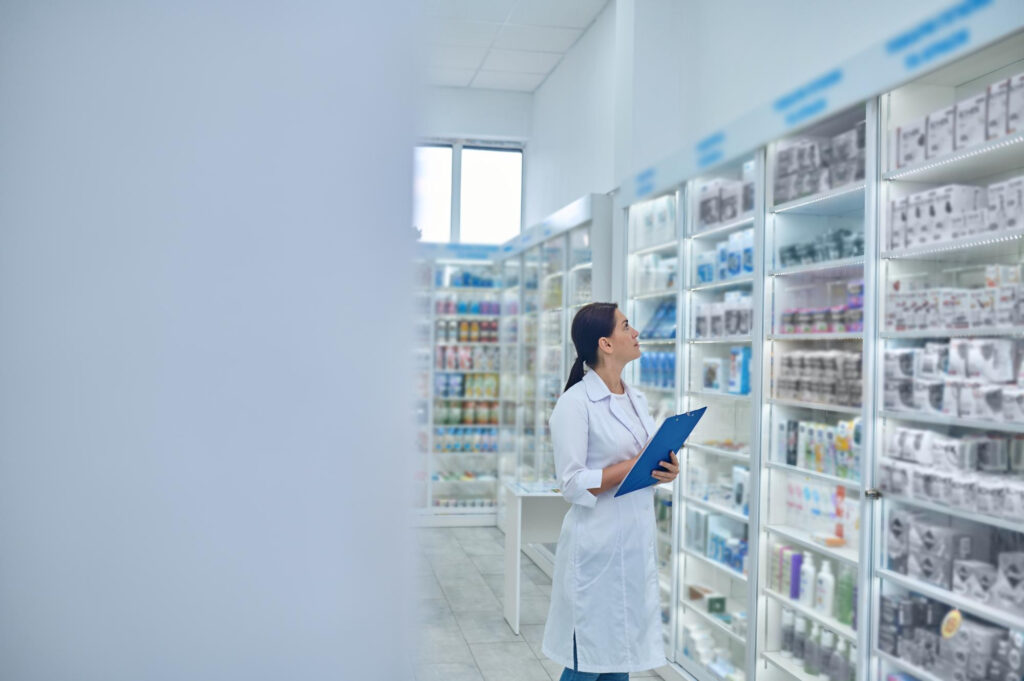 a pharmacist checking medicines at a pharmacy